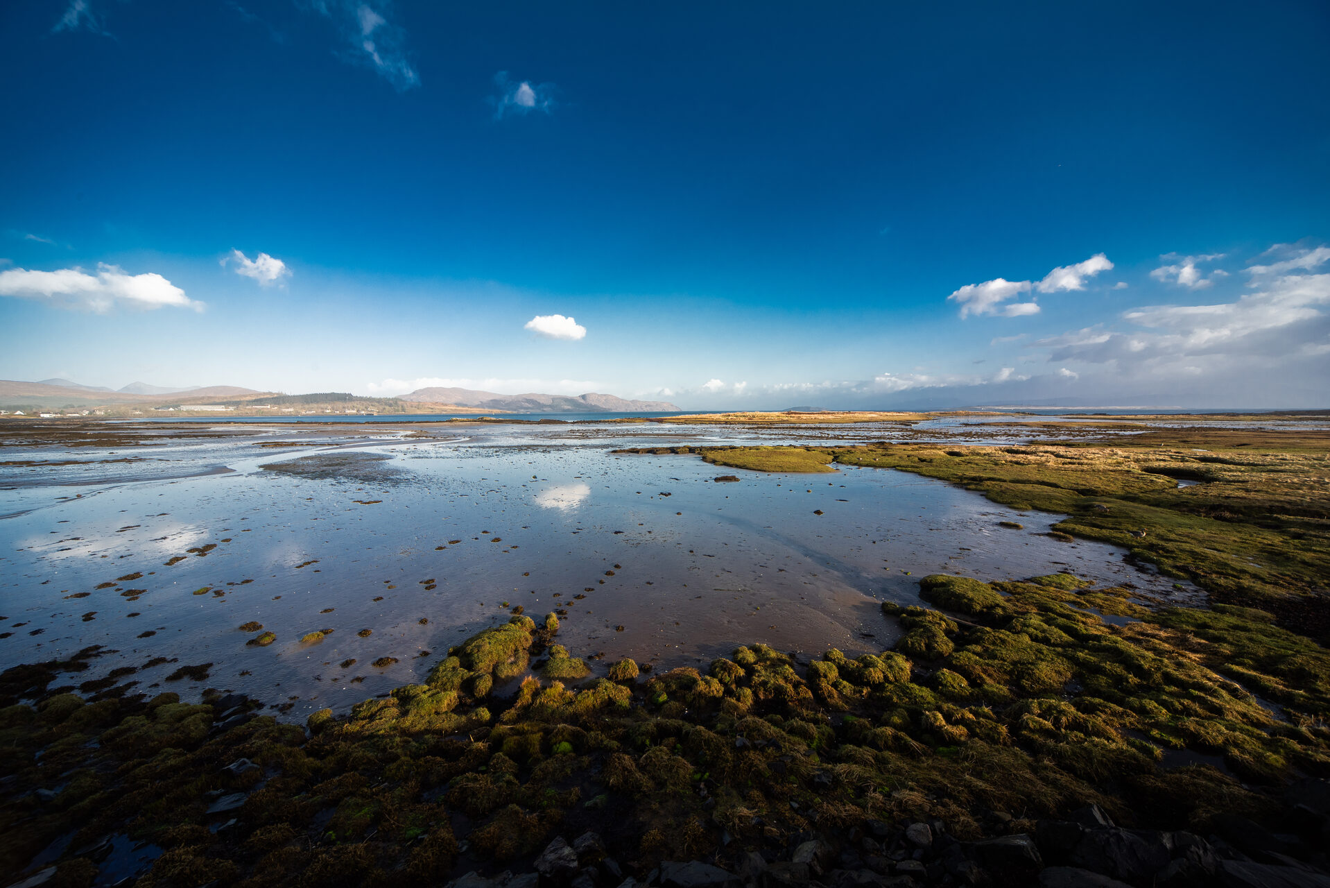 Stunning coastal landscape on the Isle of Skye with mountains in the distance