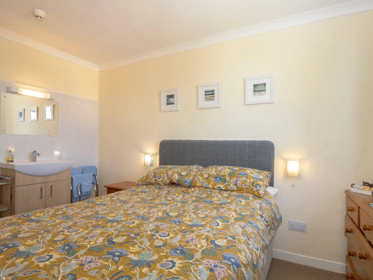 Double bedroom at Otter Lodge Skye with floral bedding