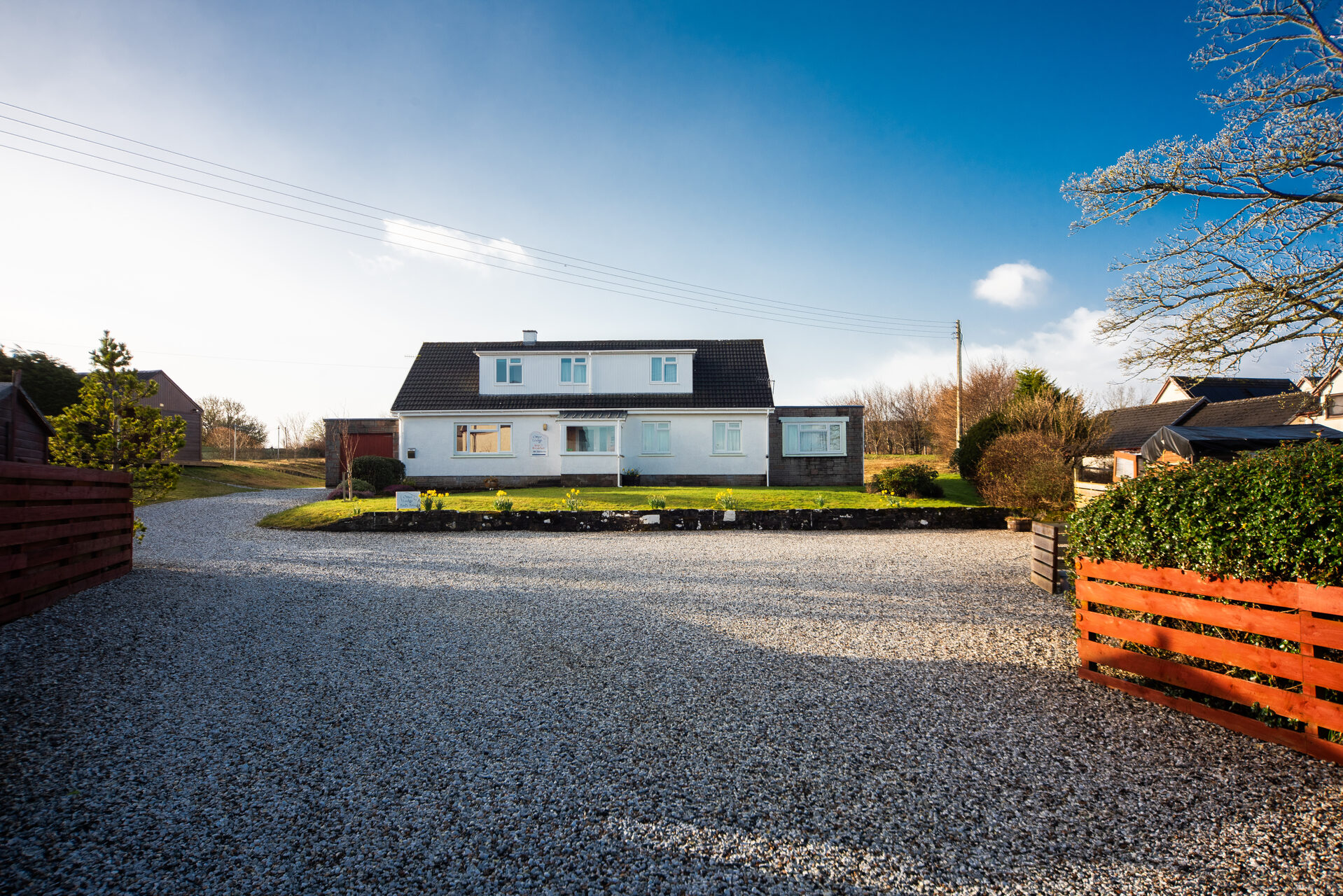 Otter Lodge Skye exterior with driveway and gardens on the Isle of Skye